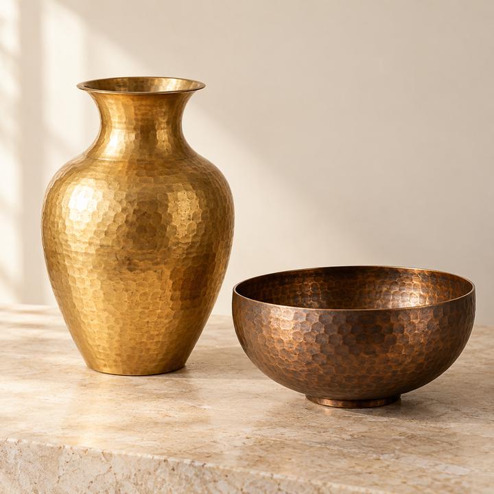 Hammered gold-coloured metal vase beside a hammered copper-coloured bowl
