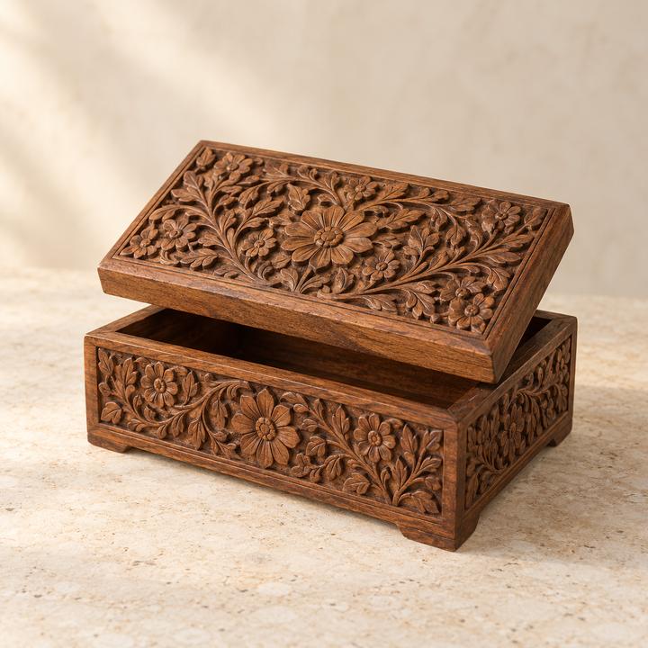 Wooden box with deeply carved floral patterns, lid raised