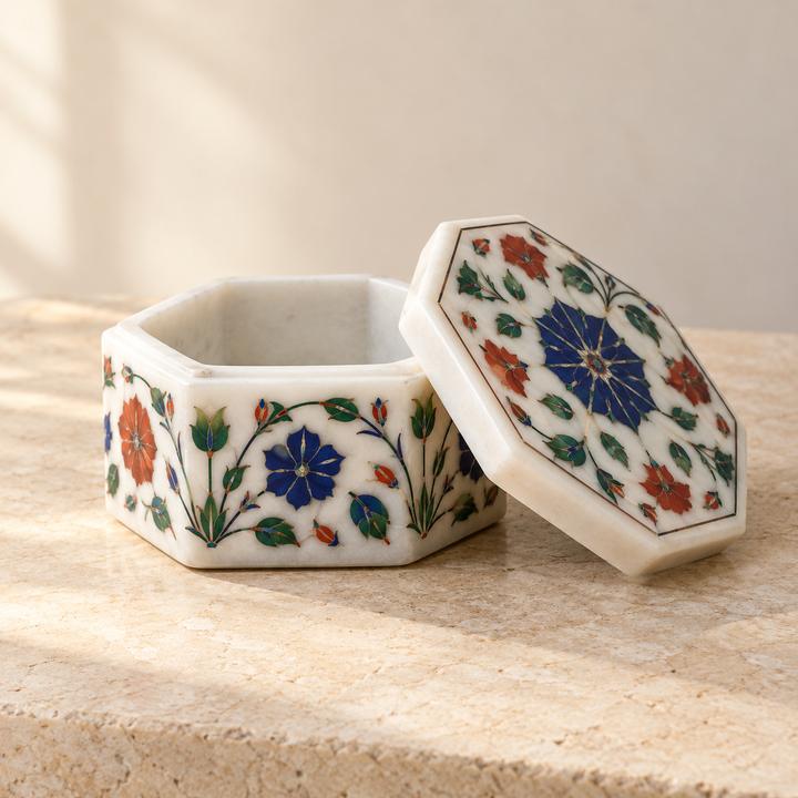 White stone box with coloured floral inlay, its octagonal lid beside it