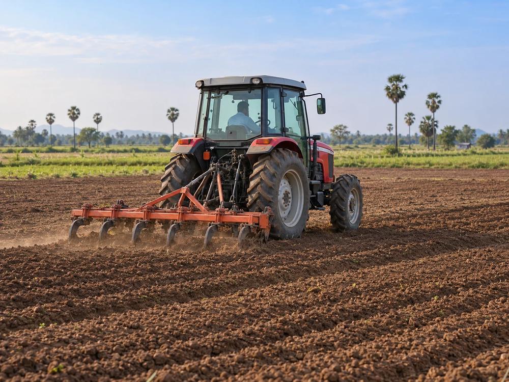 A tractor preparing a field for sowing in India